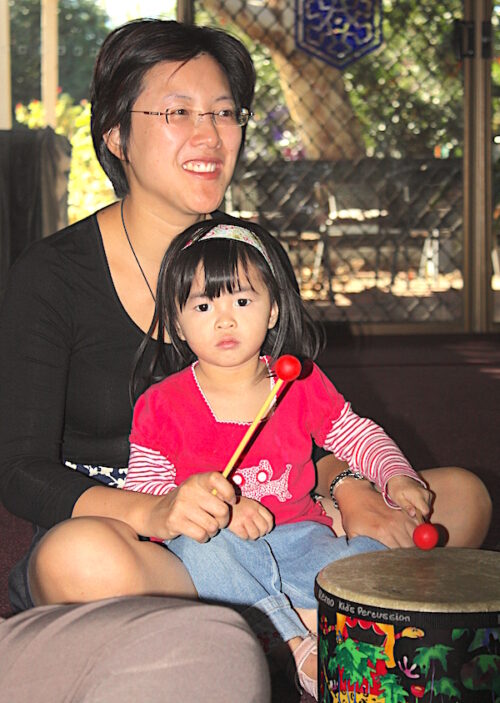 child has one beater, mother has the other for floor tom